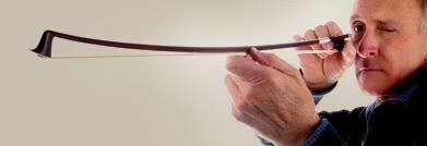 A violin bow being inspected