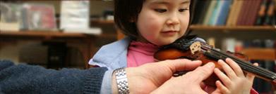 A girl practicing with a violin
